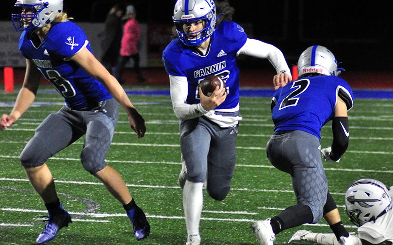 Luke Holloway (12) keeps the ball for first down during the Rebels game against Heard County Friday, December 4.