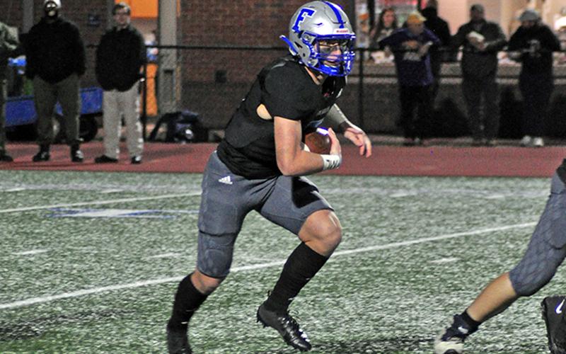 Rebel Seth Reece (5) find an open running lane during the Rebels playoff game against Fitzgerald Friday, December 11.