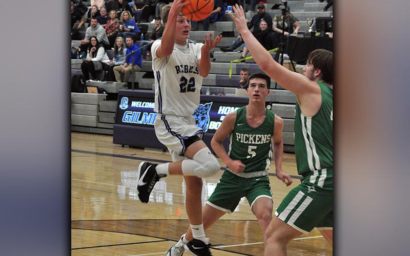 Fannin Rebel Landon Norton looks for an open man as he drives the lane in recent action for the Fannin Rebels basketball team.