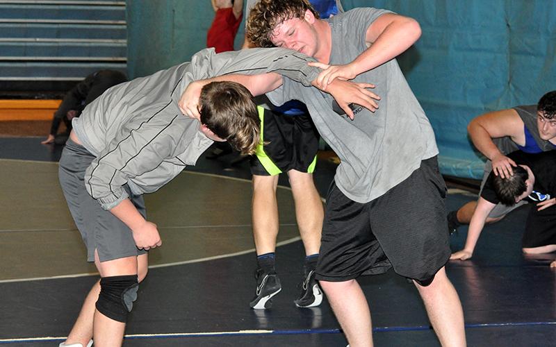 RIGHT: Matthew Crowder, left, and Jesse Daveport work on technique during the Fannin County High School Rebels wrestling practice Wednesday, December 16.