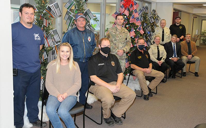 The staffs of Probate Court and Magistrate Court are honoring the county’s first responders and United States Armed Forces with a group of five special trees decorated on the second floor of the Fannin County Courthouse. Shown with the trees are, from left, seated, Victoria Weeks, EMA Deputy Director Patrick Cooke, Fire Chief Larry Thomas, Detention Center Captain Jill Huffman, Probate Judge Scott Kiker and Chief Magistrate Judge Brian Jones; and, standing, firefighters Bradley Beaver and Brad Beaver, U.S.