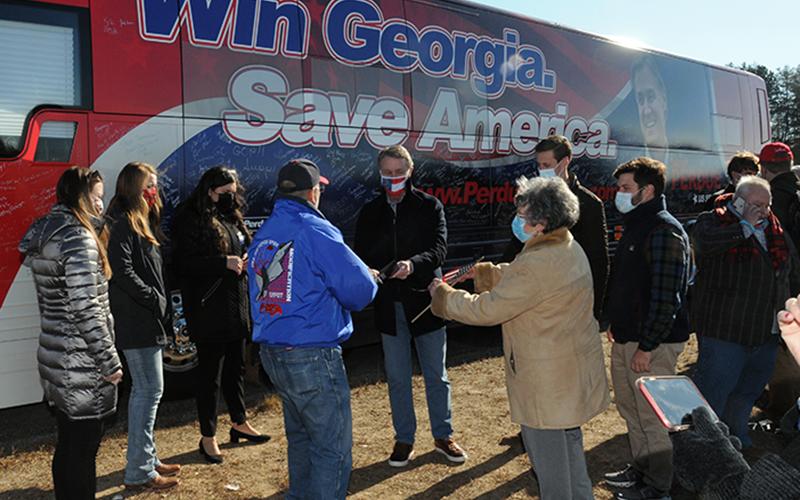 U.S. Senator David Purdue, facing a January 5 runoff election to retain his seat, met with supporters, signed autographs and had pictures made when his "Win Georgia, Save America" campaign came to Fannin County last week.