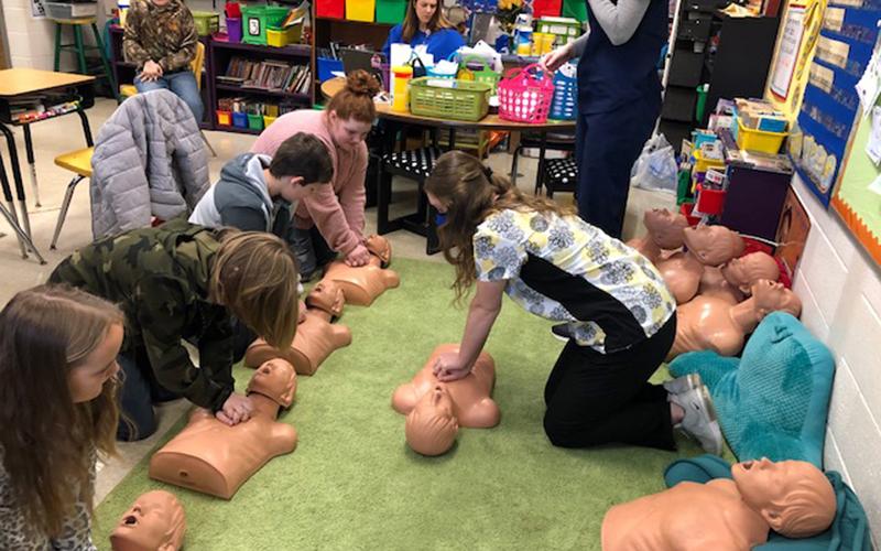 Fannin County High School Essentials of Healthcare student Cassidy Culpepper recently completed the course’s comprehensive assignment by providing a “Basic Healthcare” lesson to students at Blue Ridge Elementary School with her fellow classmates. She is shown teaching “Hands-Only” CPR to the students.