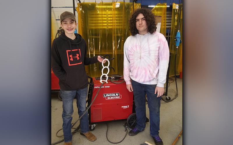 Fannin County High School welding students Ryan Pawlak, left, and Corey Riendeau are shown with a holiday snowman, which they welding using horseshoes.