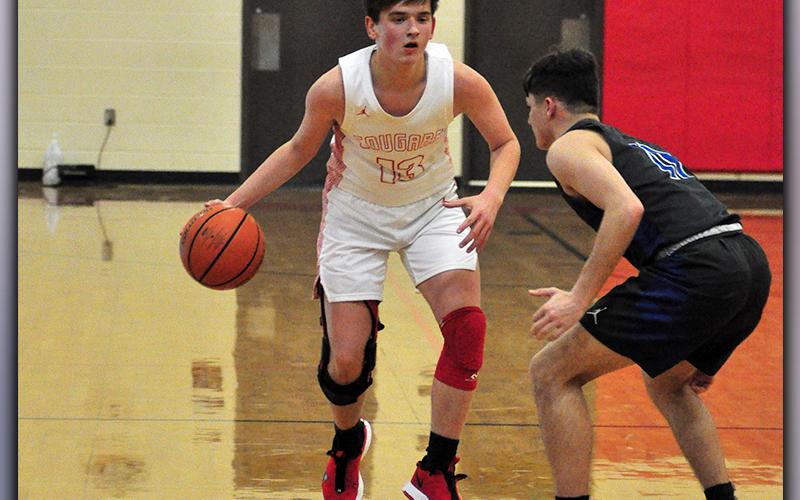Evan Bobo dribbles past a Towns County defender during the Cougars game against the Indians Monday, January 18.