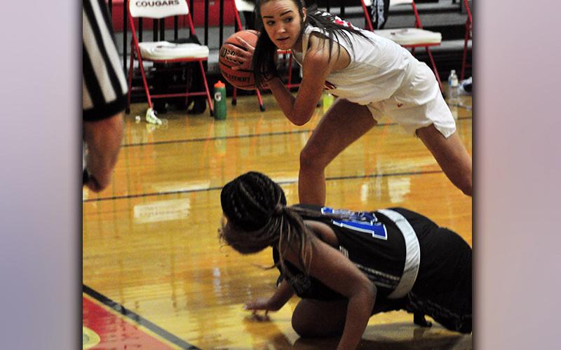 Lady Cougar Riley Smith steals the ball away from a Lady Patriot player during the Lady Cougars win against Chattanooga School for the Arts and Sciences Tuesday, January 12.