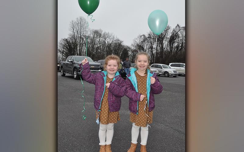 Arlie Reese Mayfield, left, and Kennedy Lynn smile with thier balloons as they wait for the balloon release to begin. The event was to celebrate the life of Sydnie Jones.