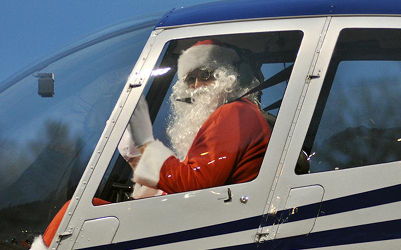 Santa Claus waves from the helicopter as he and pilot Damon Williams land at the Fannin County Recreation Department Wednesday, December 23. Santa made his appearance during a special drive-thru event. Due to COVID-19 restrictions, he wasn’t able to visit personally with children, but his appearance brightened many faces.