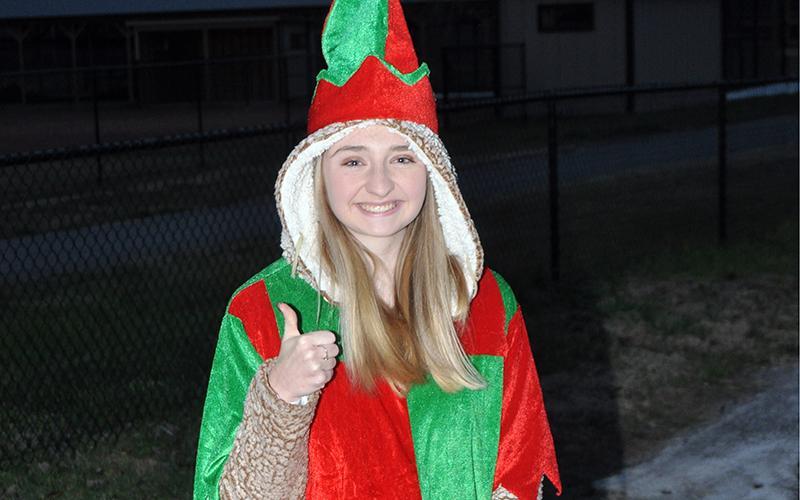 Santa’s helper, Taylor Tarpley, is all smiles and thumbs up as she gets ready to hand out goodies to young visitors during Santa’s visit to the Fannin County Recreation Center Wednesday, December 23.