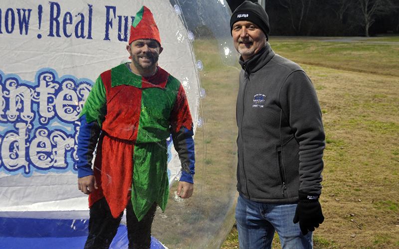 Santa’s helper Tim Towe took up his duties in a snow globe next to Fannin Recreation Department Director Eddie O’Neal during Santa’s visit to the Fannin County Recreation Center Wednesday, December 23.