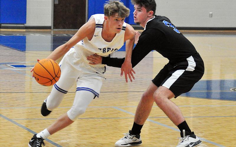 Rebel Kaeden Twiggs forces his way around a defender in recent action for the Fannin County Rebels basketball team.