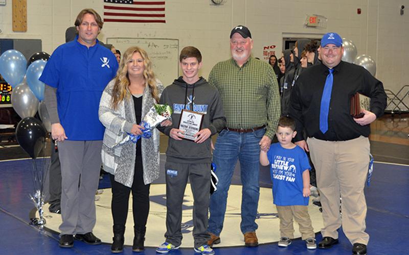 Kolton Stephens was one of seven seniors honored at Fannin County High School wrestling senior night Friday, January 15. Shown during the ceremony are, from left, Coach Alan Collis, mother, Robin Stephens, Stephens, father, John Stephens, nephew, Anderson Cheek, and Coach Chuck Patterson.
