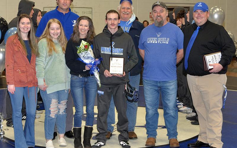 Fannin senior Kainan Henson was honored before the Rebels Area Duals Friday, January 15. shown during the ceremony are, from left, sister, Kirstie Henson, Avery Henson, Coach Alan Collis, mother, Mary Henson, Henson, grandfather, Mike Henson, father, Mark Henson, and Coach Chuck Patterson.