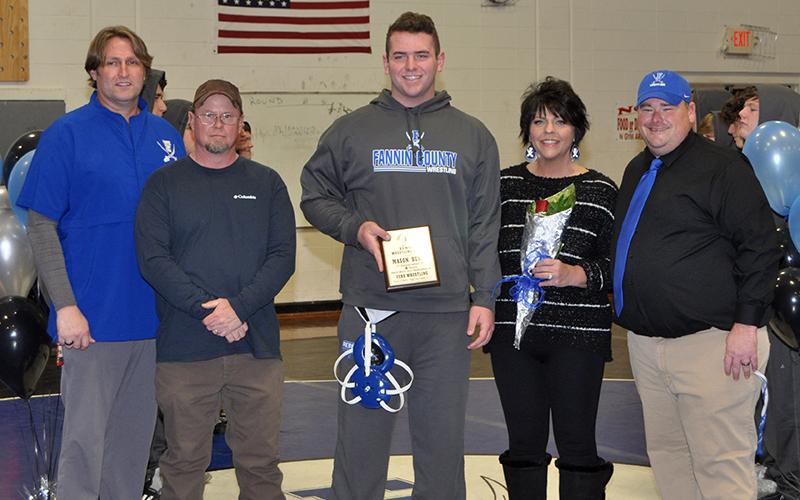 Senior Mason Bundy was recognized with six other seniors during Fannin wrestling senior night, Friday, January 15. Shown during the cermony are, from left, Coach Alan Collis, father Chris Johnson, Bundy, mother, Deana Johnson, and Coach Chuck Patterson.