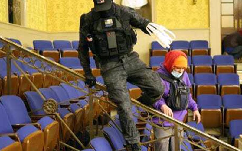 This photo of an individual, referred to on the internet as the “zip tie guy,” taken inside the Senate’s Chamber dressed in paramilitary gear and holding zip ties is believed to be Eric Gavelek Munchel, a 2009 graduate of Fannin County High School.