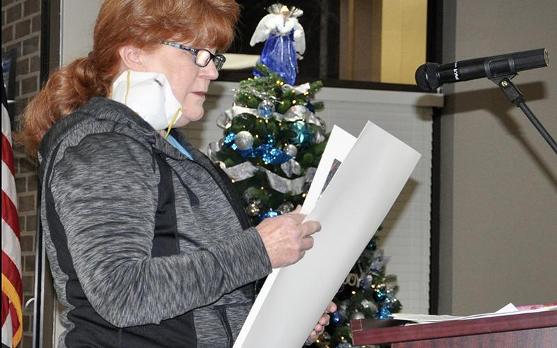 Donna Thompson, left, presents screenshots of a Facebook interaction with Planning Commission Chairman John Soave in which he provided misinformation regarding what can be built under a General Commercial zoning.