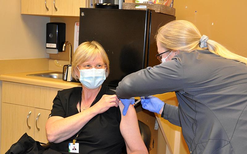 Georgia Mountains Health Nurse Lesa Parker was one of the first in Fannin County to receive the Moderna COVID-19 vaccine Wednesday, December 23. The injection is the first of two shots. The second round must be completed 28 days after the initial injection. Nurse Kiersten Lanier is shown administering the vaccine.