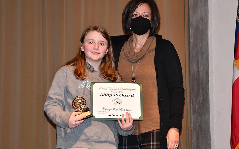 West Fannin Elementary School student Abby Pickard placed third in the Fannin County School System District Spelling Bee where she competed against students from East Fannin Elementary, Blue Ridge Elementary and Fannin County Middle School Thursday, January 14. She is shown with her principal, Alison Danner.