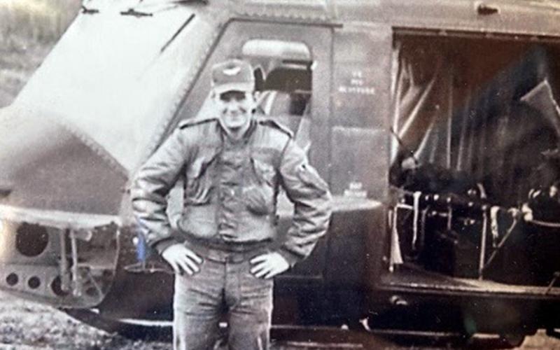 During his time in the Army, Rod McIntyre worked on and flew helicopters, such as the one shown behind him. He spent the majority of his time during the Vietnam War stationed at Camp Holloway.