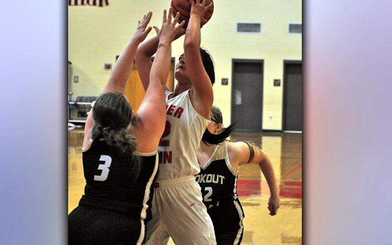 Skyler Nipper shoots a contested two-point jumpshot over a Yellow Jacket defender during the Lady Cougars basketball game against Lookout Valley Thursday, February 18.