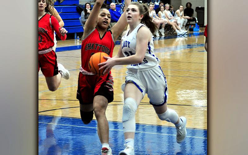 Abby Ledford gets past a defender in recent action for a two-point basket for the Lady Rebels.