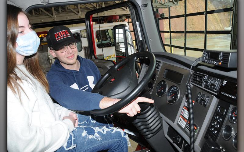 Vance Collins, one of Fannin County's newest firefighters, explains the workings of a fire engine to his sister, Jonnah. While this demonstration was not part of the class conducted for public officials, it was another example of how firefighters reach out to the public, family and friends alike, to explain everything that is included in their efforts.