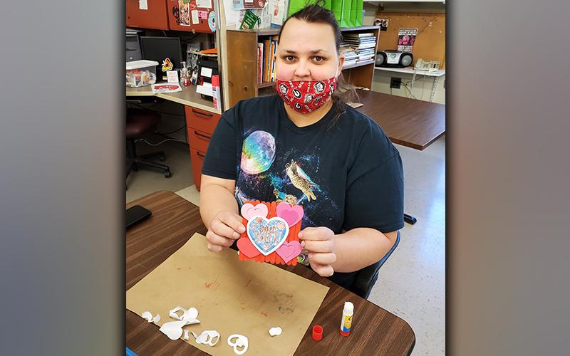 Amanda King shows off her Valentine’s Day craft made at the Mineral Springs Center, Inc.