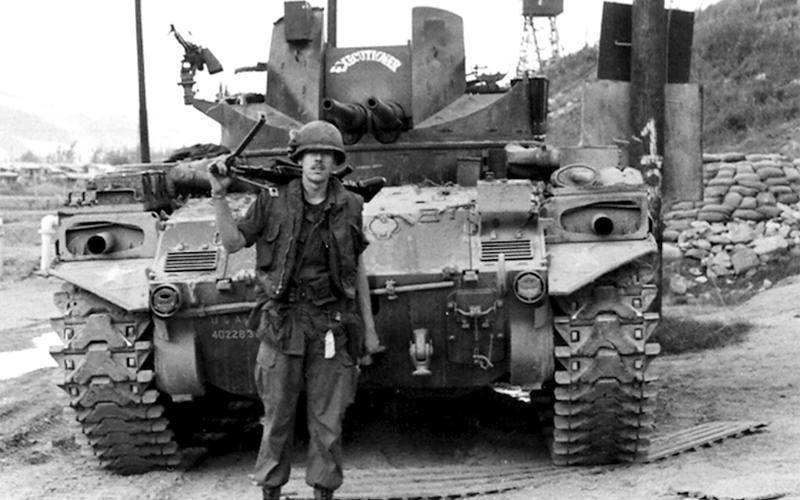 Army veteran Paul Hunter stands with a tank he worked on during the Vietnam War, which bears the inscription, “Executioner.” While Hunter worked on tanks, he also spent six and half months in an infantry unit.