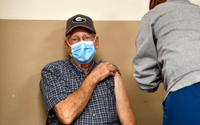 Bob Daves held his shirt sleeve up as he patiently waited to receive his COVID-19 vaccination from Tamra Head with the Fannin County Health Department Monday February 8.