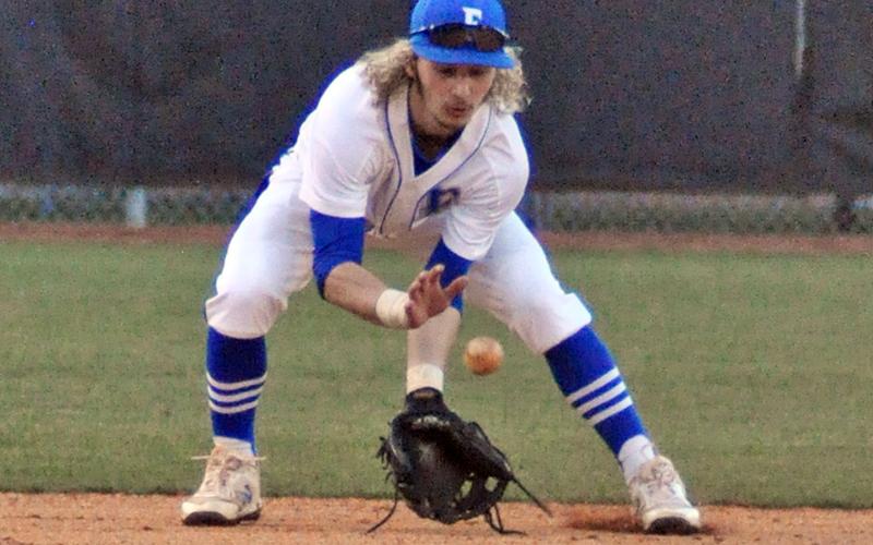 Wyatt Rogers scoops up a ground ball during the Rebels’ game against Union County Wednesday, February 24.