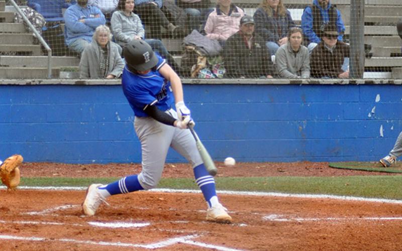 Logan Hughes unloads on a pitch during the Rebels’ game against Gilmer County Tuesday, March 2.