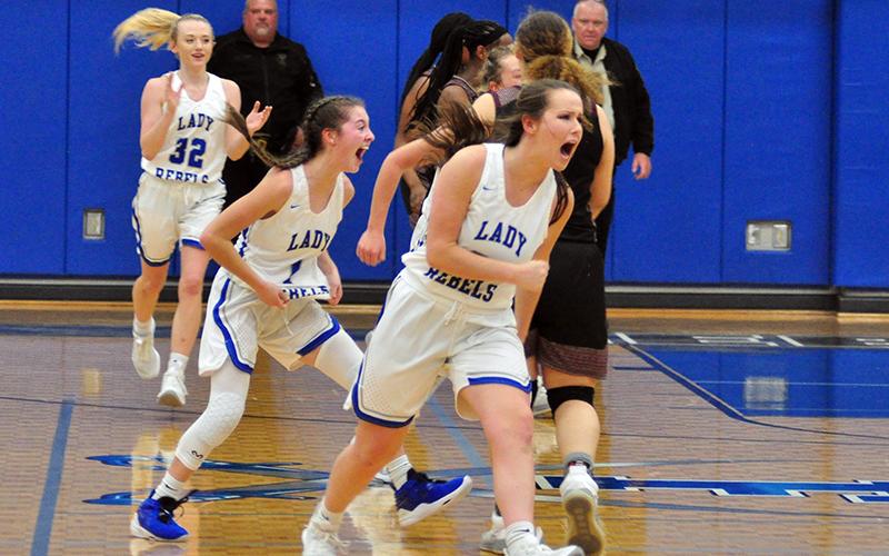 Lady Rebels Mackenzie Johnson (32), Courtney Davis (1) and Natalie Thomas (30) celebrate as the clock hits double zeros in their Sweet Sixteen win against Heard County Friday, February 26.