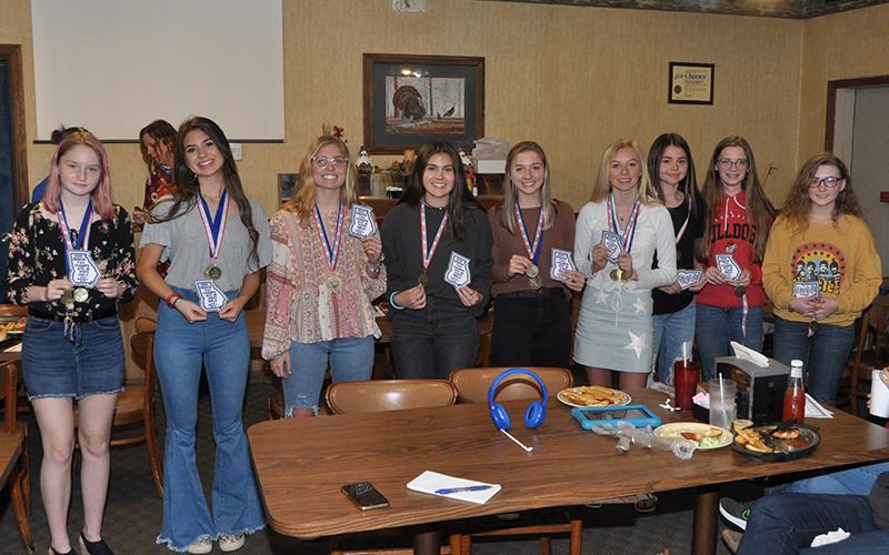 The Fannin County Lady Rebel cross country runners were award patches for their lettermen jackets for winning the Region 7AA Championship and placing sixth in the state. Shown following the presentation are, from left, Erin Jones, Monica Consentino, Kinsley Sullivan, Taylor Poland, Hannah Sosebee, Carlee Holloway, Kristin Cipich, Olivia Temples and Shaylee Jones. Not pictured, Teagan Cioffi.