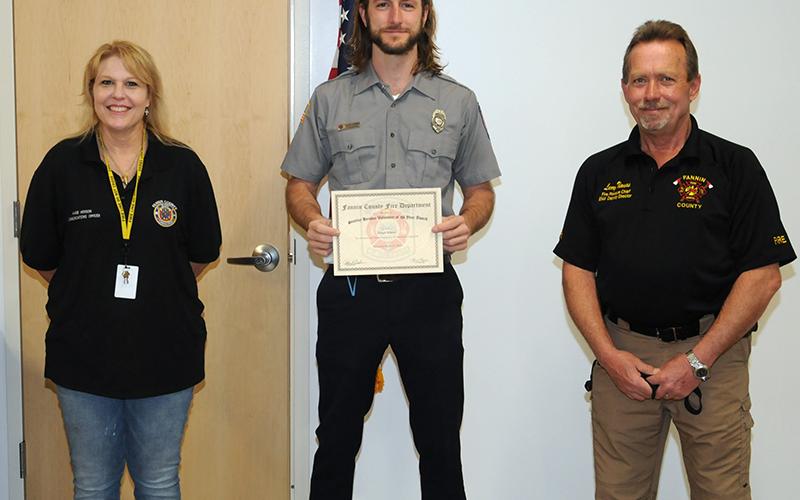 Joseph Scherer, center, received the "Stanley Henson Memorial Volunteer Award" for his outstanding service to the Fannin County Fire Department and Rescue Squad. He is shown with Henson's widow, Angie, and Fire Chief Larry Thomas.
