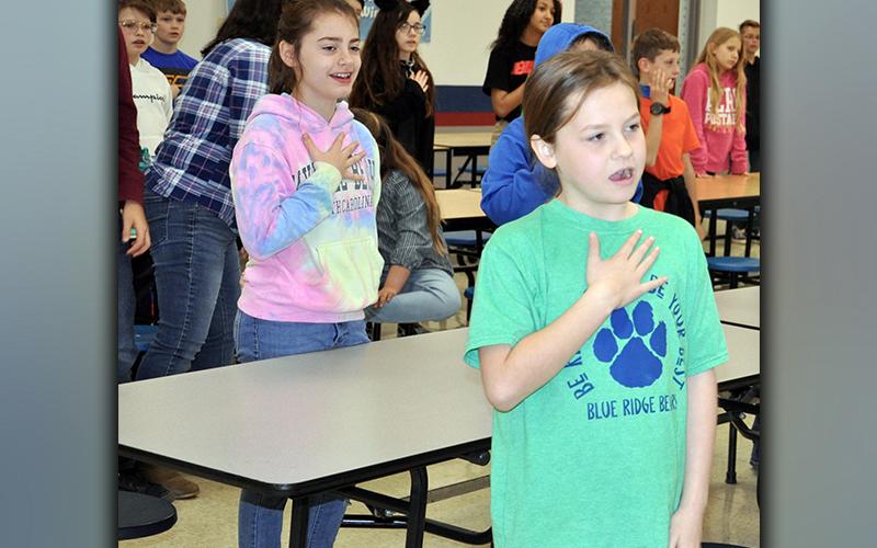4-H Project Achievement Awards were presented to Blue Ridge Elementary School fourth and fifth grade students Tuesday, March 23. Shown performing the 4-H Pledge are, from left, Olivia Hill and Lynnex Patterson.