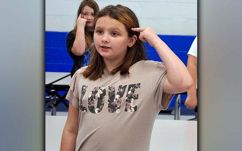 East Fannin Elementary School students Summer Bryant, front, and Kylie-Anne O’Neal recite the 4-H Pledge during the county’s first-ever 4-H Project Achievement Awards Wednesday, March 24.