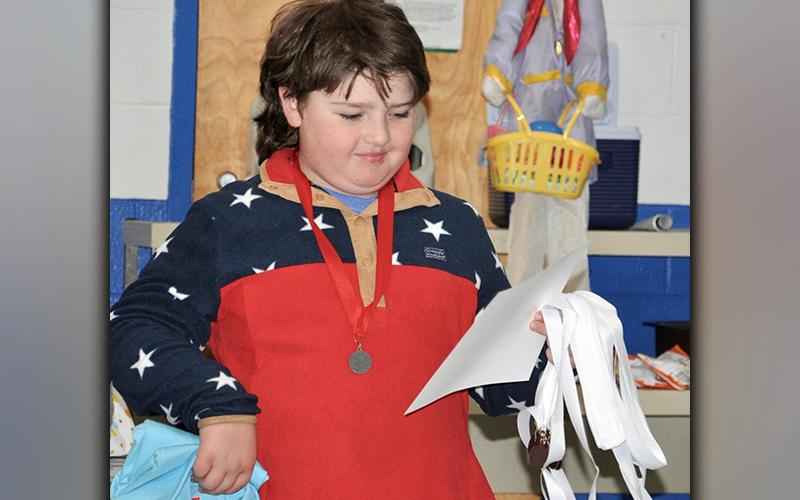 Jake Ware checks out his second place certificate during East Fannin Elementary School’s 4-H Project Achievement Awards ceremony Wednesday, March 24.