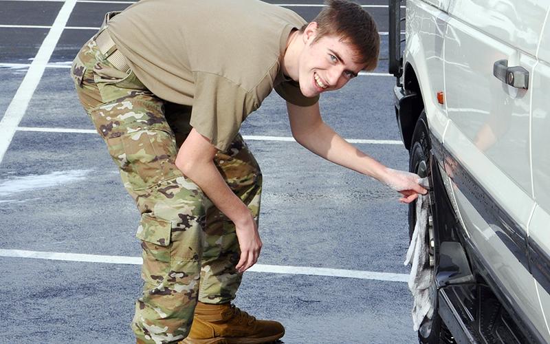 News Observer photo/Mollie Allen Mountain Area Christian Academy JROTC Senior Airman Regan Hooper cleans some wheels.
