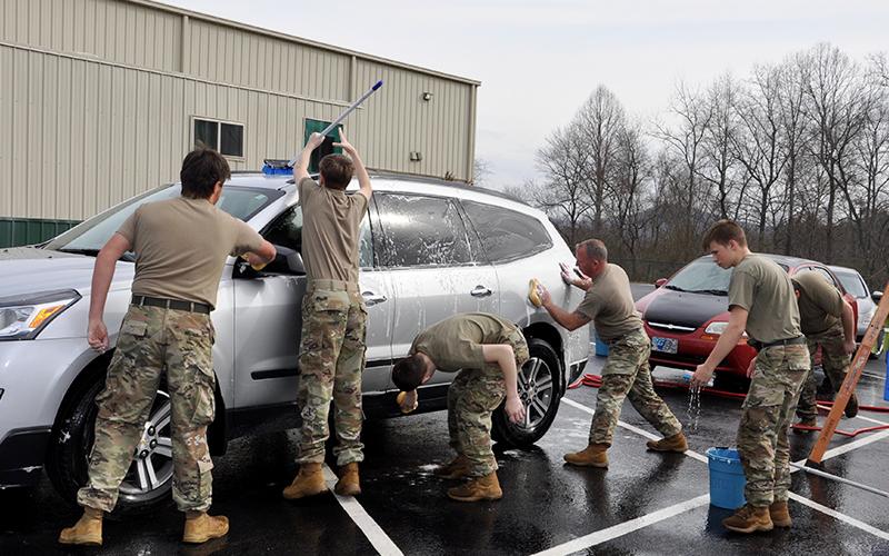 Mountain Area Christian Academy’s JROTC tackle a SUV during a car wash fundraiser Friday, March 12, to raise funds to visit Washington D.C., Arlington National Cemetery and the many war memorials there.