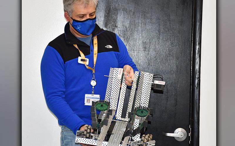 Fannin County High School Engineering/Video teacher Bubba Gibbs displays a robot created in one of his robotics classes to demonstrate the opportunities CTAE can provide to students.