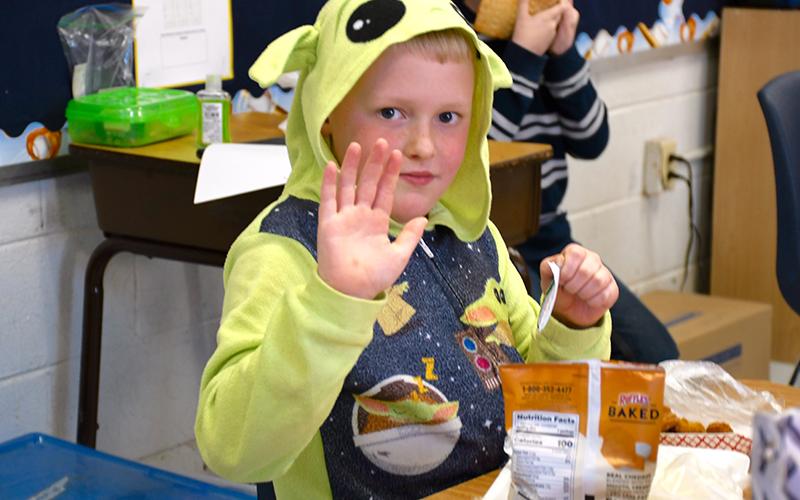 East Fannin Elementary School student Ty Cochran waves in his Baby Yoda pajamas during the school’s Read Across America Pajama Day.