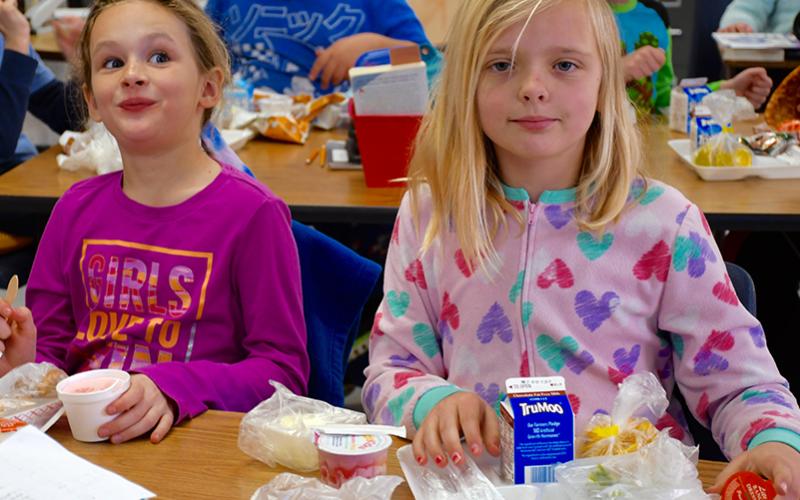 East Fannin Elementary School students Emery Collins and Lauren Hess took a quick lunch break during the school’s Read Across America Week Pajama Day.