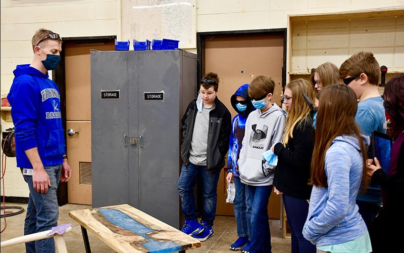 Fannin County High School construction teacher Daniel Stewart shows off a resin table that one of his students completed to fifth grade students from East Fannin Elementary School to demonstrate the types of projects they could work on if they participate in CTAE in the future.