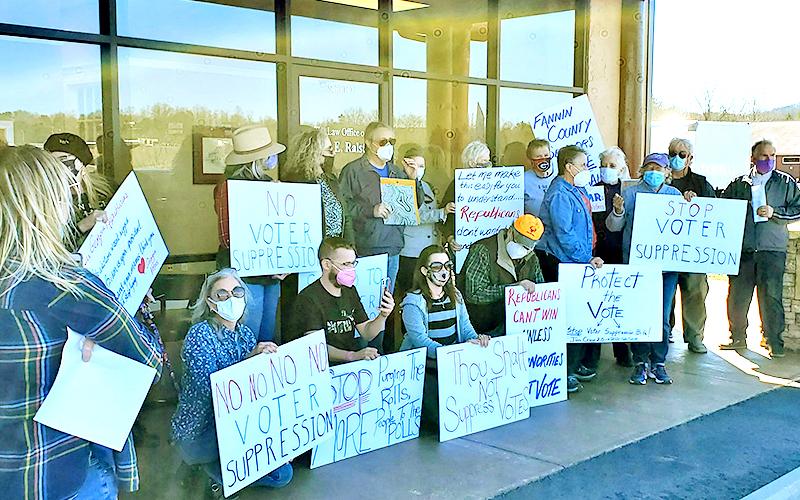 A group of concerned voters who claim Fannin, Gilmer, Pickens and Rabun County addresses protested voter suppression outside of Georgia Speaker of the House David Ralston’s law office in Blue Ridge Thursday, March 4. While the group was able to slip a letter addressed to Ralston under the door, they were asked to leave by law enforcement.