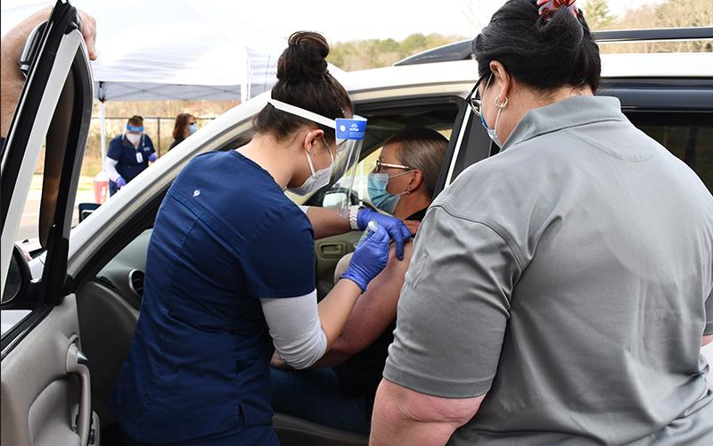 North Georgia Technical College (NGTC) student Danielle Nguyen vaccinates Fannin County School System nutrition employee Janice Brown.