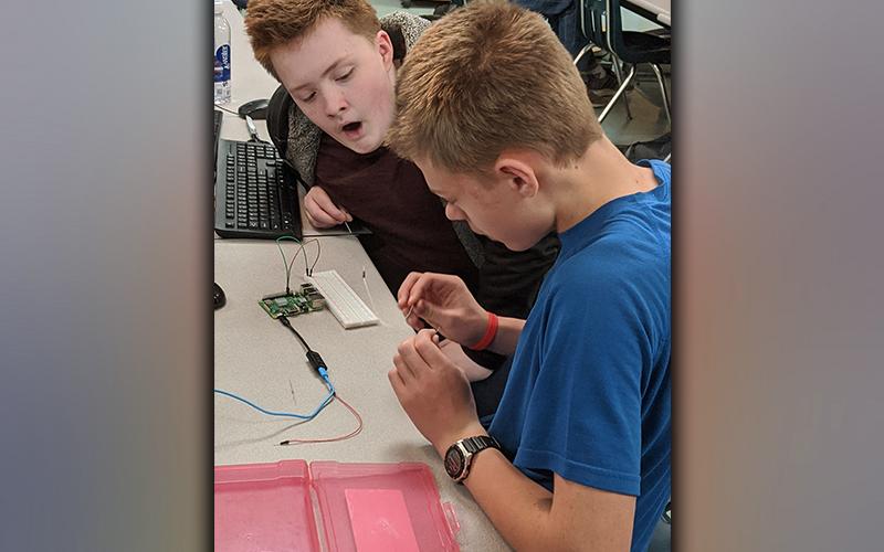 Fannin County Middle School students Steven McBee and Steven Dickey programming LED lights with a Raspberry Pi, which is a small computer used to learn programming.