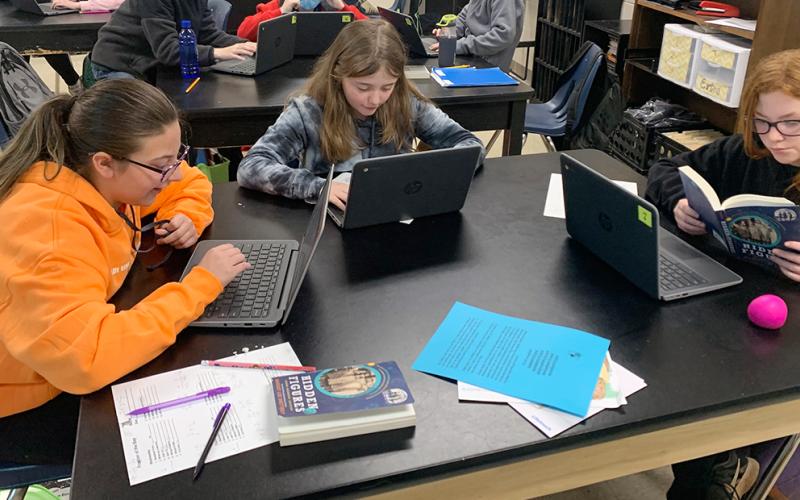 West Fannin Elementary School students Caroline Cole, Abby Pickard and Londyn Hobson are shown, from left, using their chromebooks to complete classroom assignments.