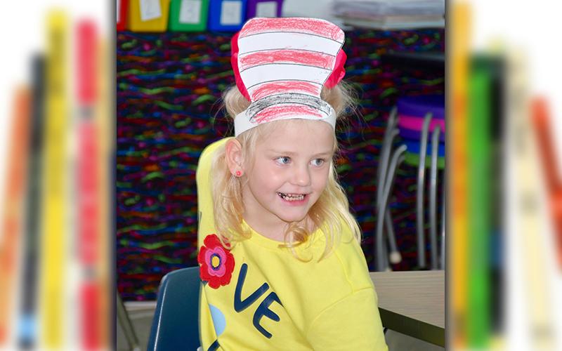 West Fannin Elementary School student Summer Cockerham smiles big as she gets ready for another Dr. Seuss story during Read Across America Week.