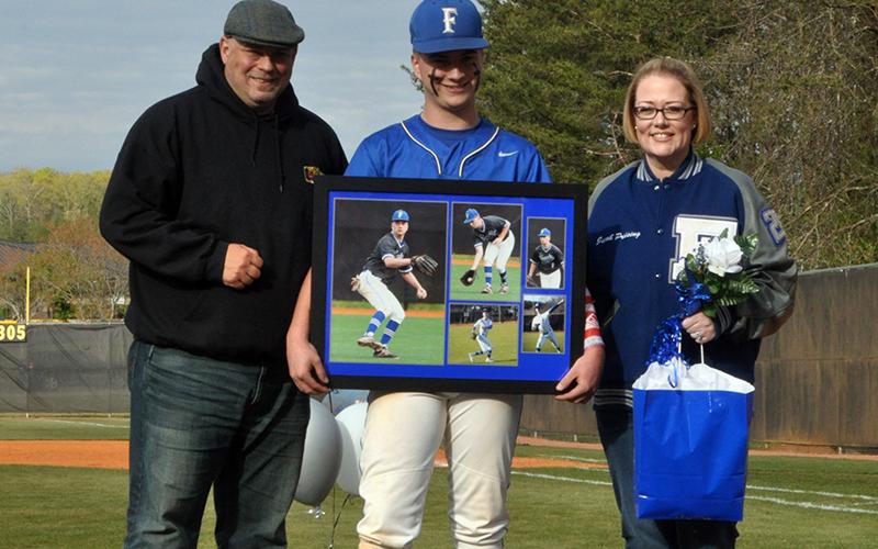 The Fannin County Rebels baseball team celebrated seven senior Rebels between games against Chattooga Friday, April 23. Senior Jacob Preising is shown with his parents Dave and Kelly Preising.