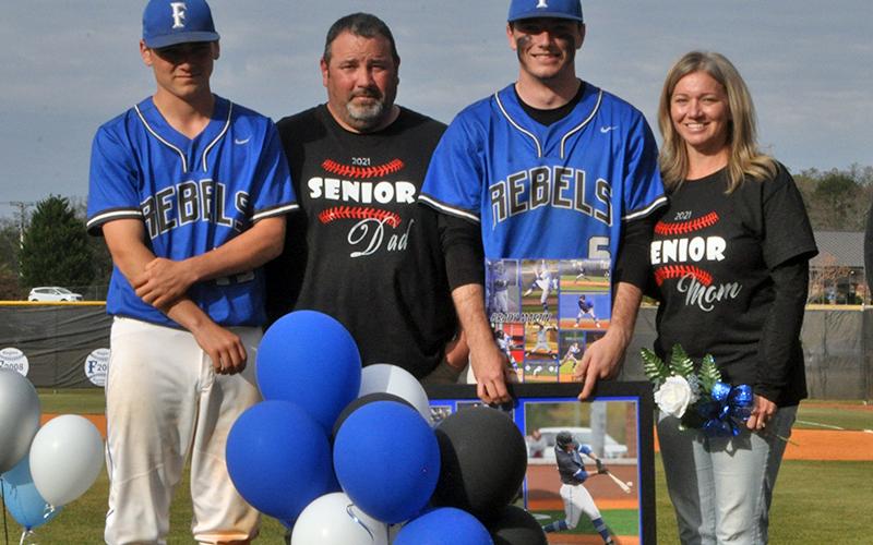 Brady Martin was one of seven Fannin County seniors honored in between games at the Rebels' double header against Chattooga Friday, April 23. Shown are from left, Connor Martin, brother; Mitchell Martin, father; Martin; and Teresa Martin, mother.